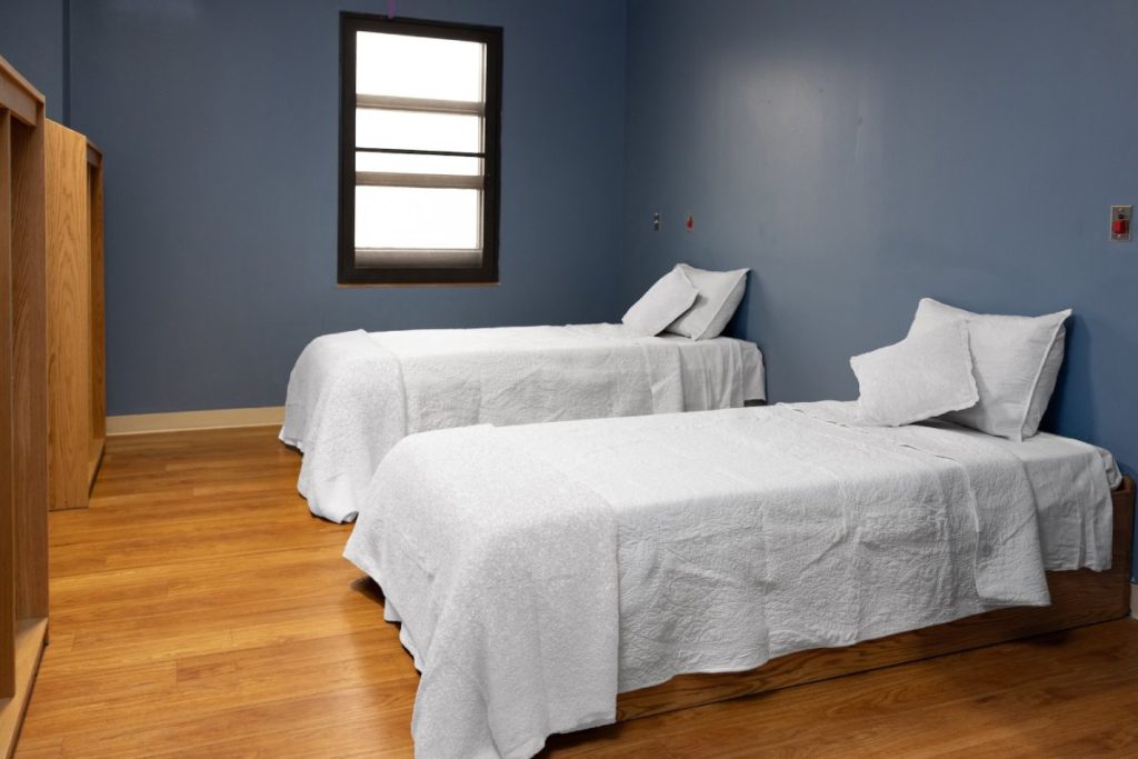 A view of two white beds