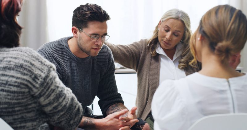 A man in therapy surrounded